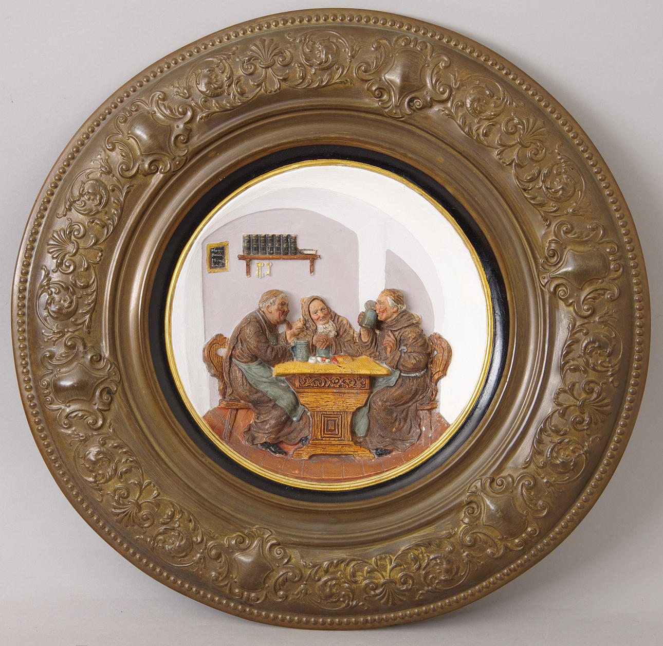 RELIEFTAVLA I MÄSSINGSRAM, drickande munkar.