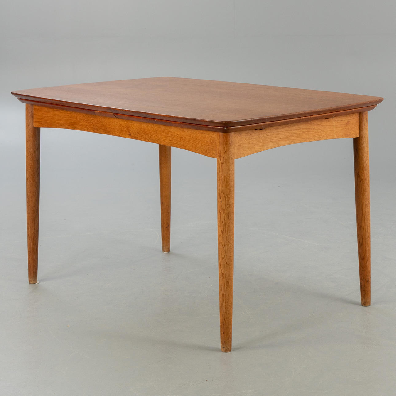 IB KOFOD LARSEN. Slagelse Møbelvaerk A/S. Extendable dining table, teak & oak, with tools. Denmark, 1950s/60s.