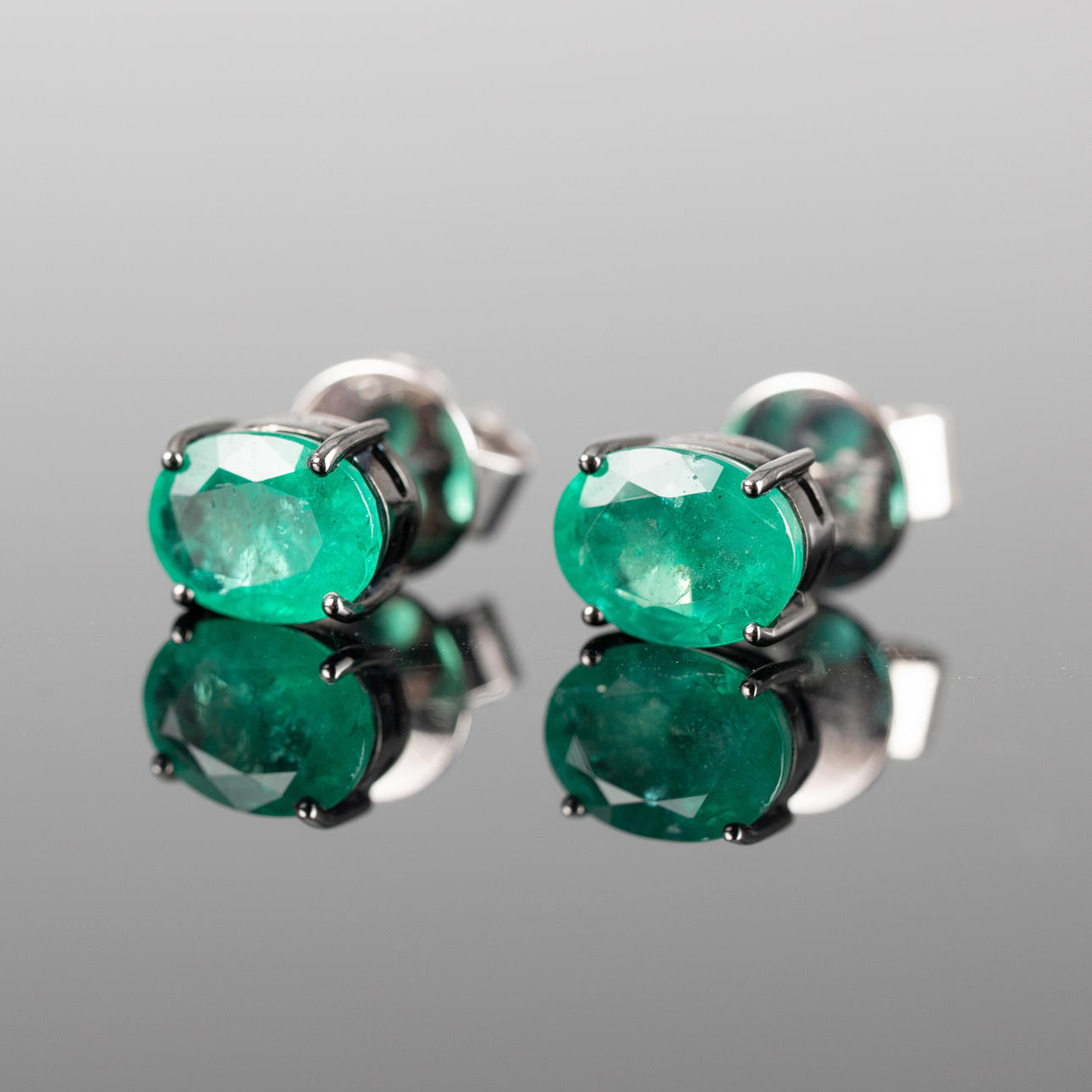 Stud earrings with emeralds.