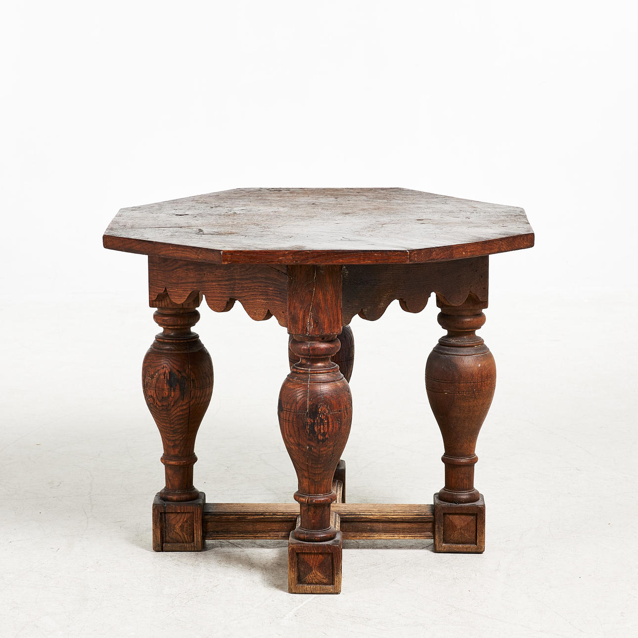 TABLE, late 19th century, stained oak frame, octagonal top, baluster-shaped legs.