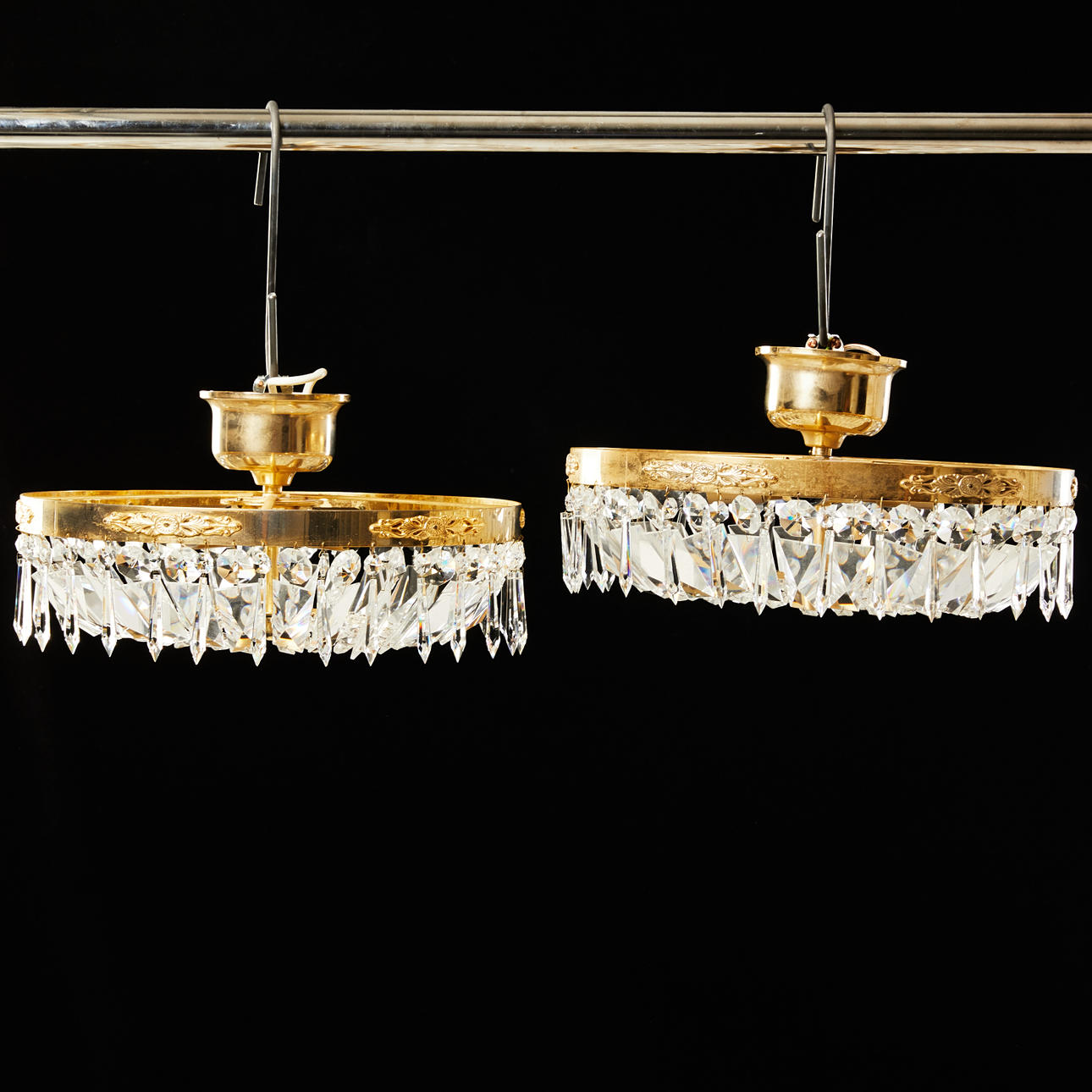 CHANDELIERS, a pair, differently shaped prisms, 4 light points per lamp, marked Ringus AB, second half of the 20th century.