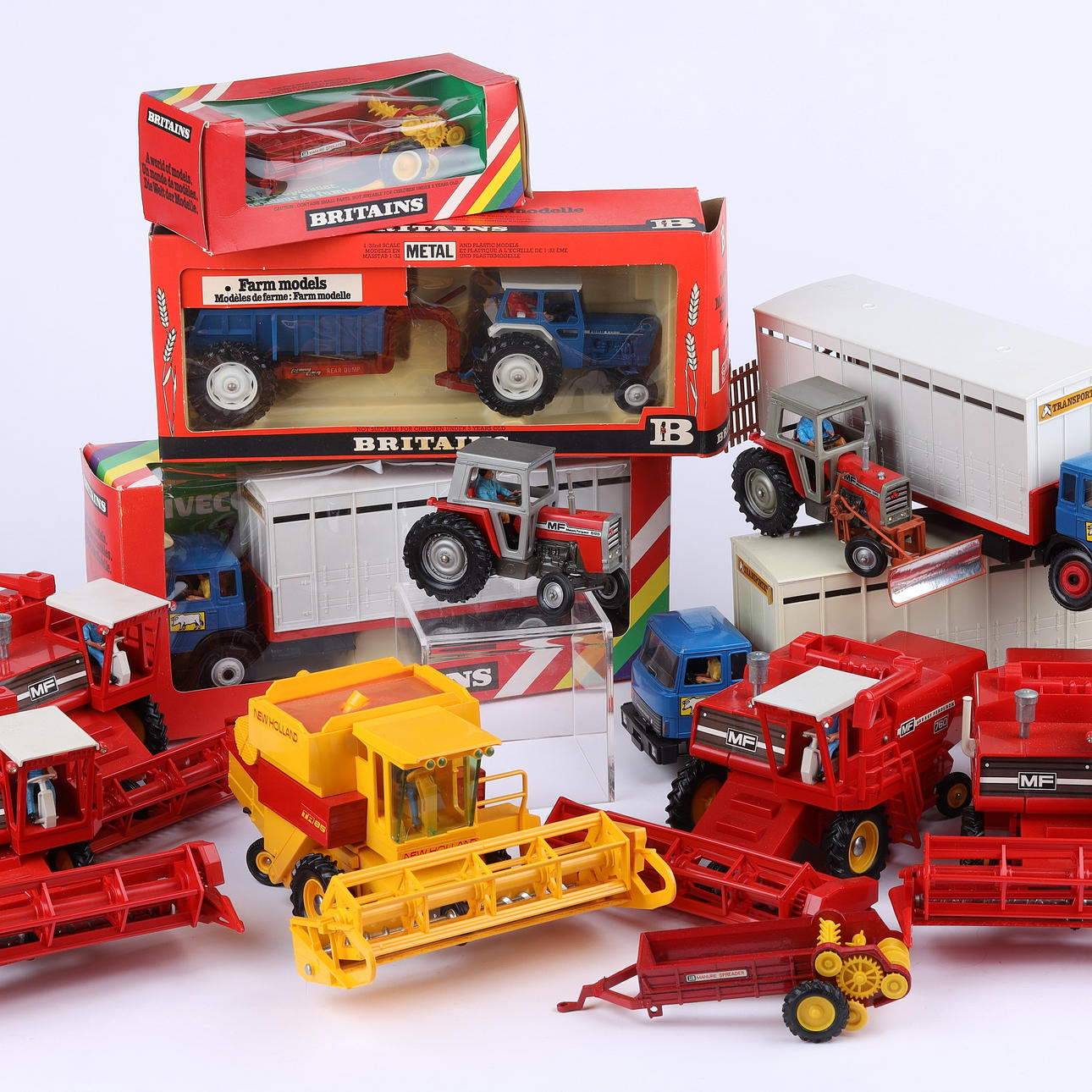 A small collection of Britains farm tractors and implements, comprising