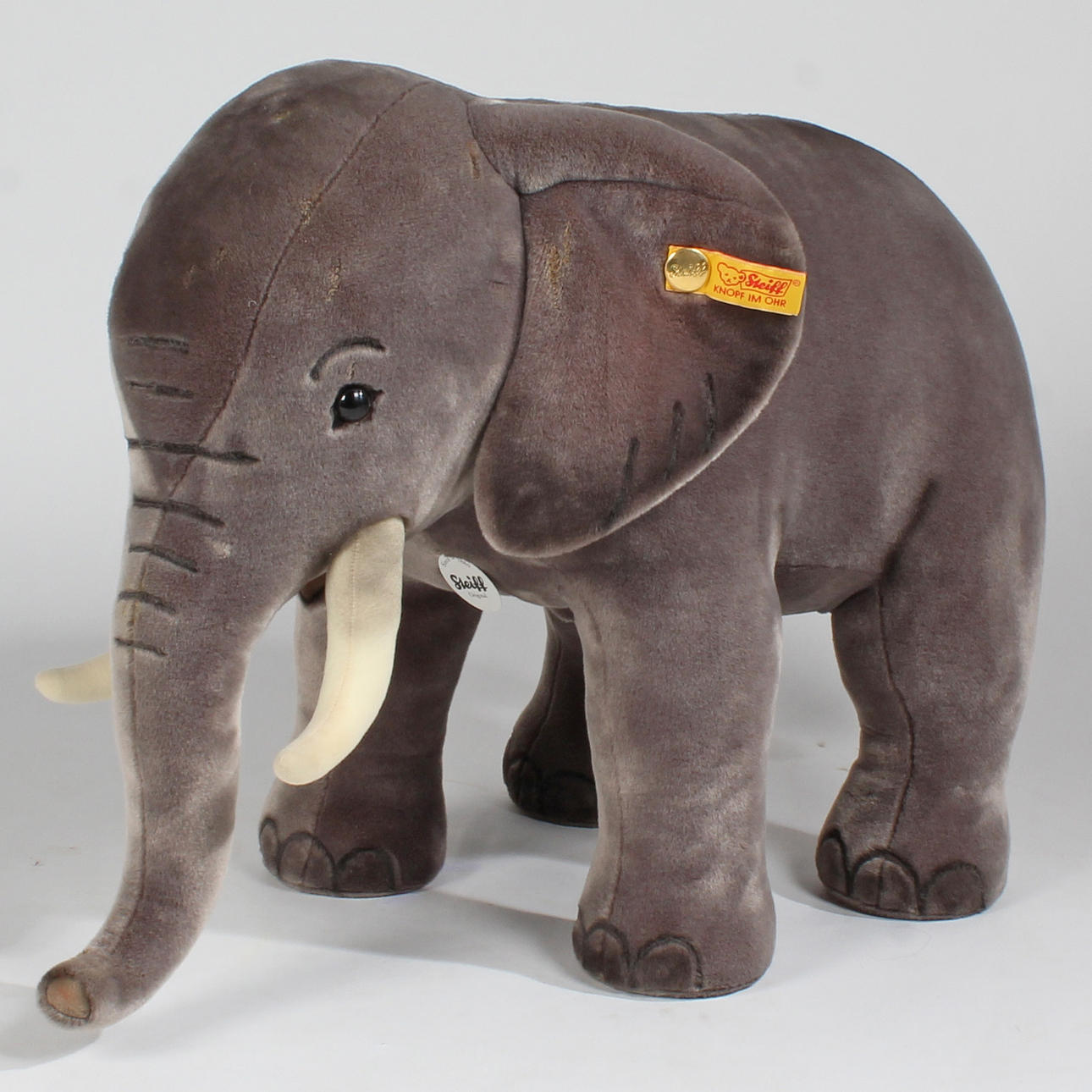 A STEIFF ELEPHANT WITH BUTTON AND LABEL.