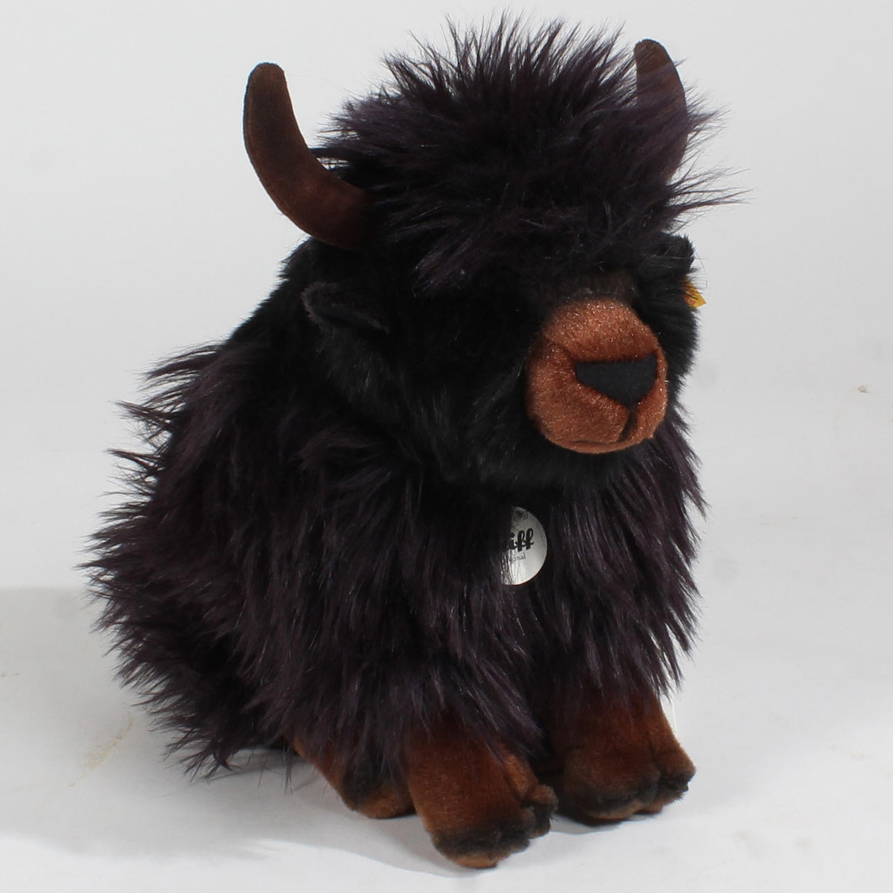 A STEIFF YAK 'JACKIE' WITH BUTTON AND LABEL.