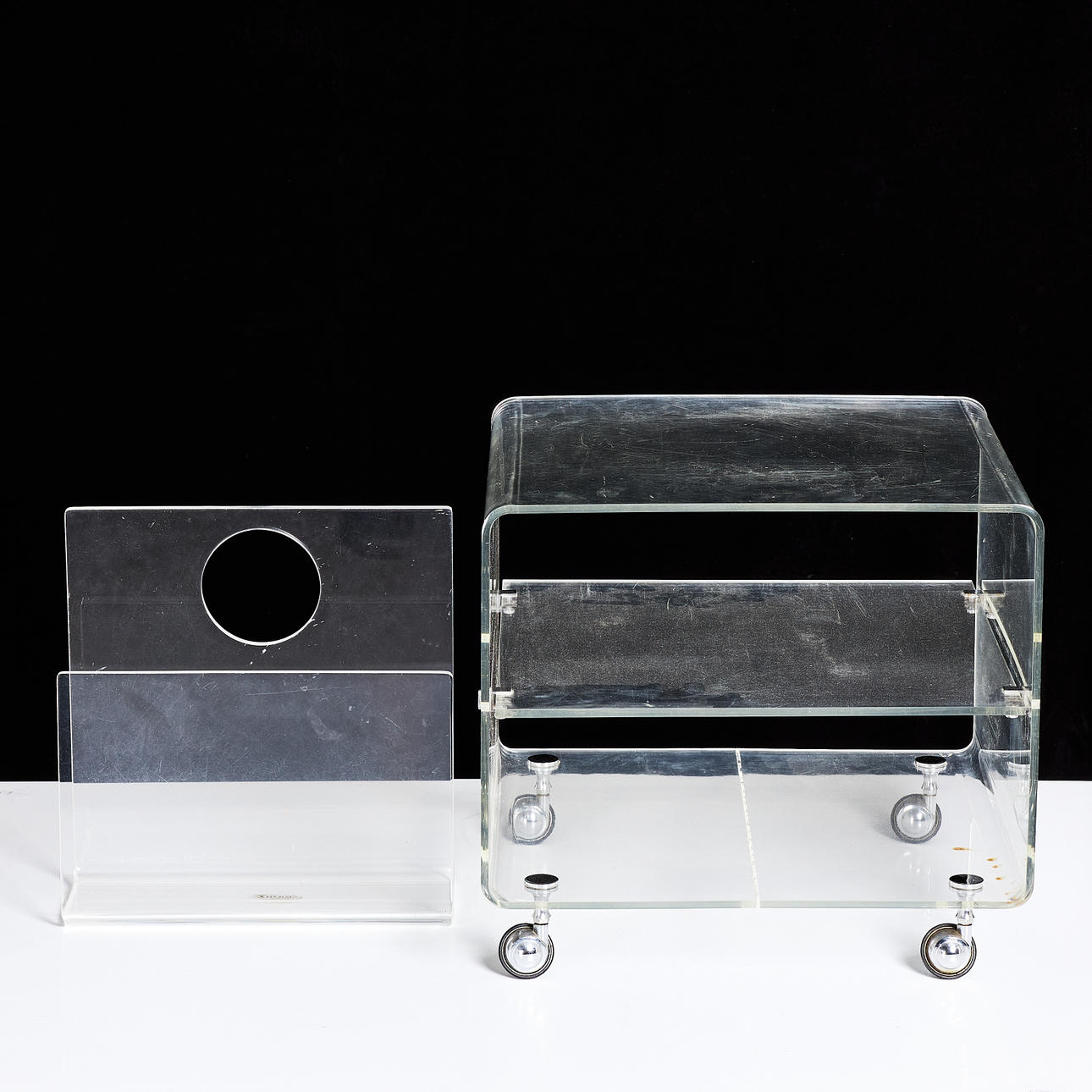 SIDE TABLE on wheels, NEWSPAPER RACK, 1970s, plexiglass, newspaper rack marked Ferguson Formdesigns, England.