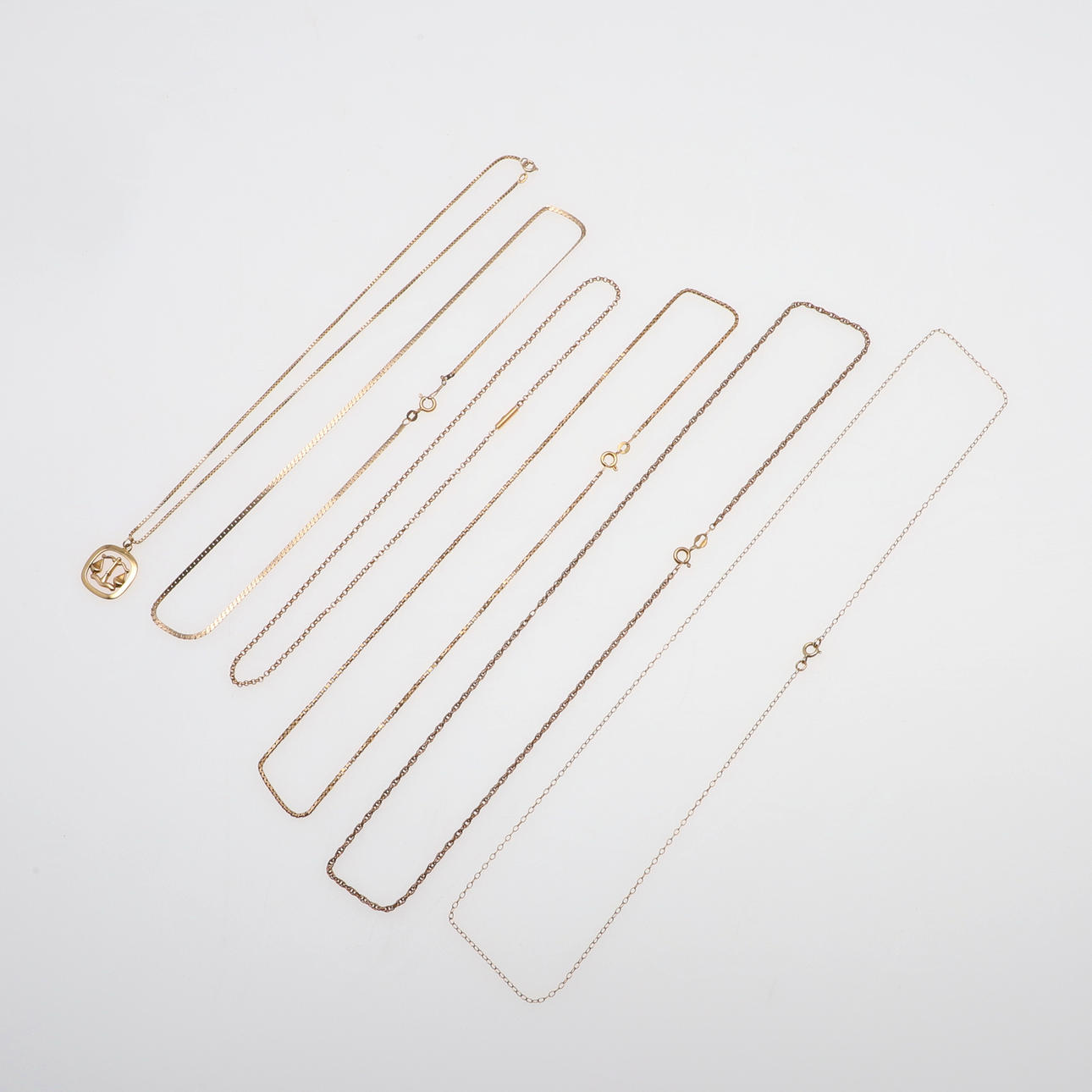 A 9CT GOLD PENDANT AND 9CT GOLD CHAINS.