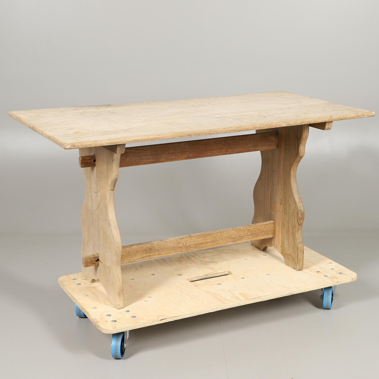 A STRIPPED PINE STRETCHER TABLE.