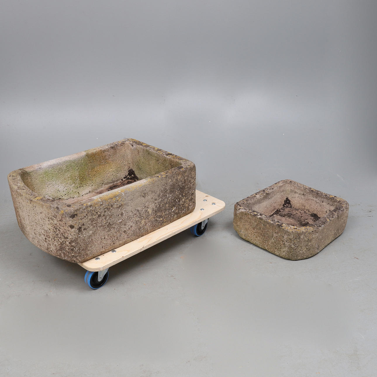 A WEATHERED SANDFORD STONE OBLONG PLANTER.