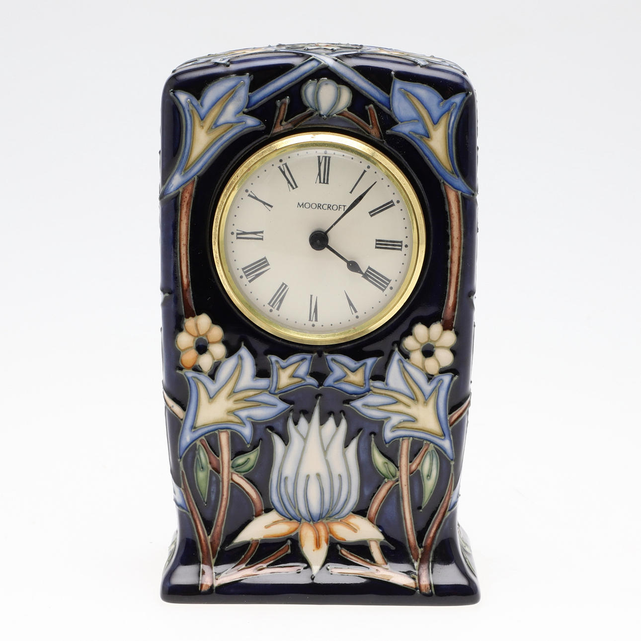 A MODERN MOORCROFT POTTERY MANTEL CLOCK.
