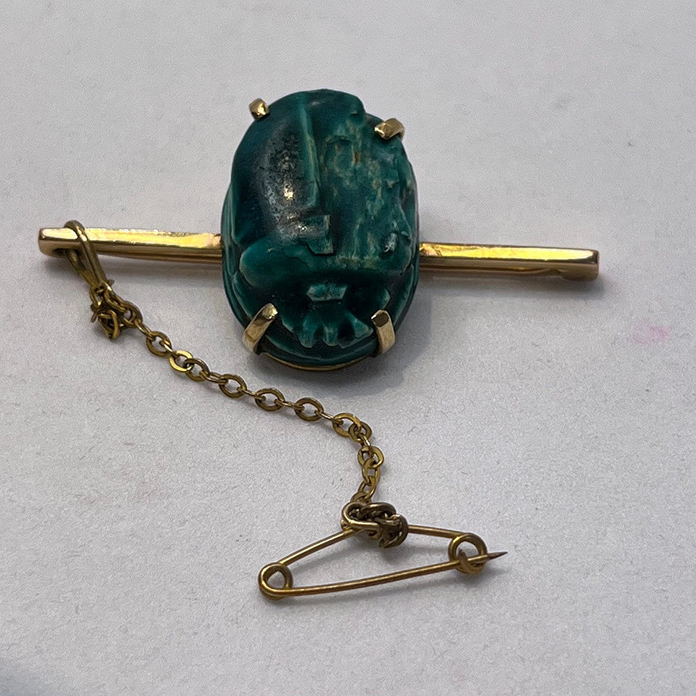 - Guld keramisk scarab brosch.