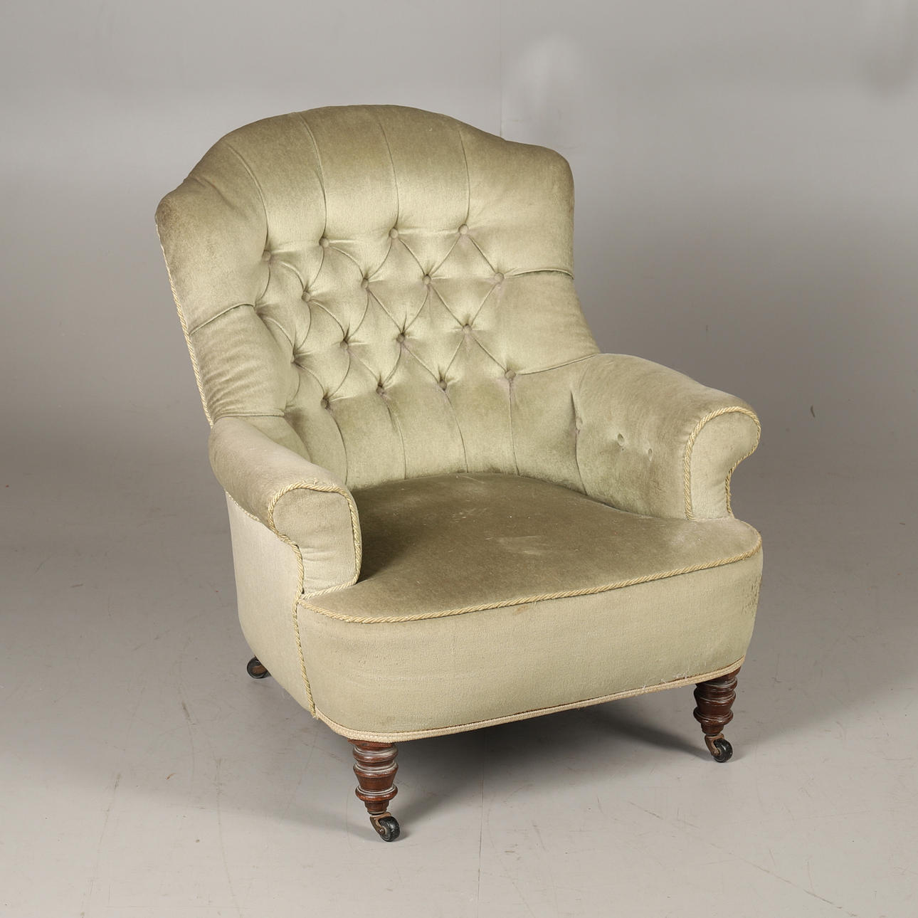 A VICTORIAN BUTTON BACK ARMCHAIR.