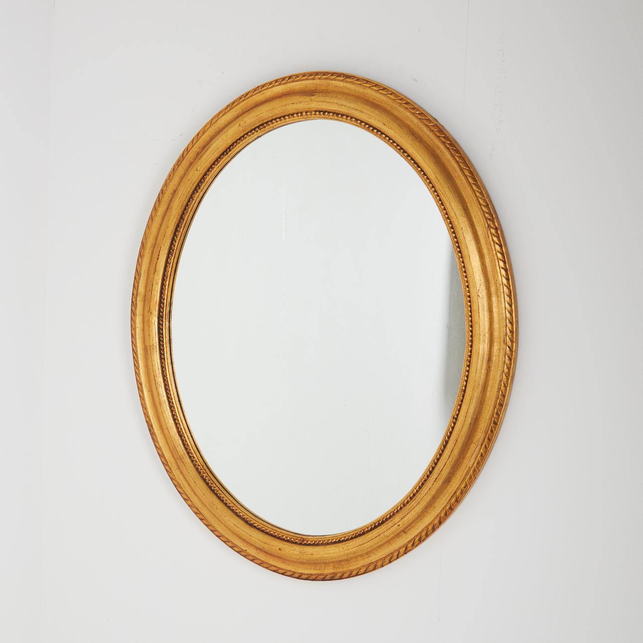 MIRROR, oval shape, 20th century, gilded.