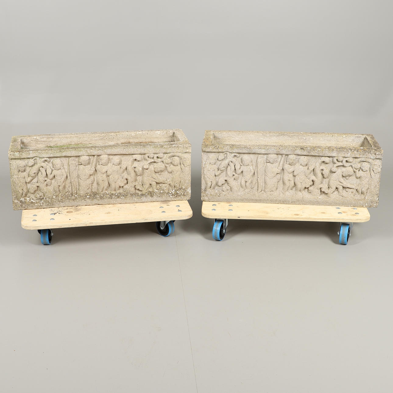 A PAIR OF RECONSTITUTED STONE TROUGH PLANTERS.