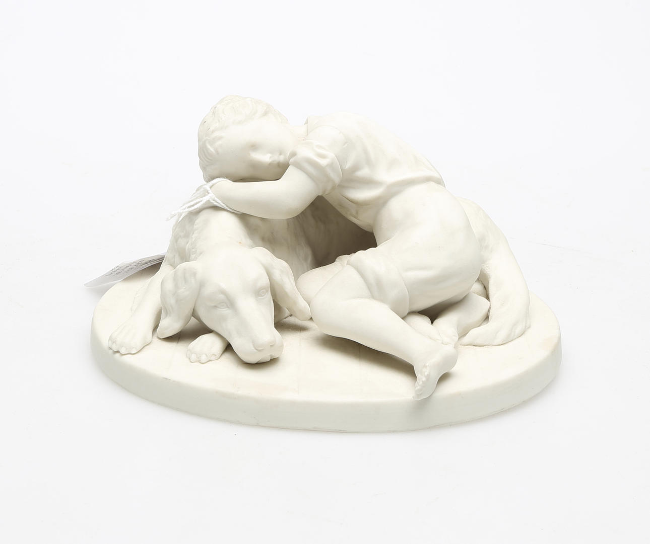 FIGURIN, parian, "Hund med pojke" efter A. Rudenschöld, Gustafsberg 1920, stämpelsignerad.