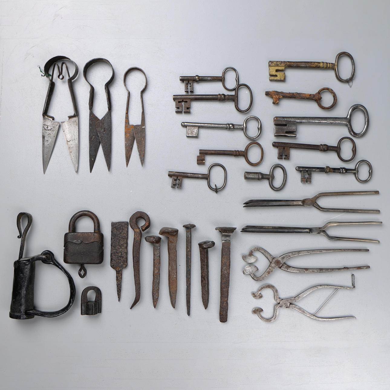 COMMON OBJECTS in iron, including keys, locks, scissors, pliers, 18th-19th century.