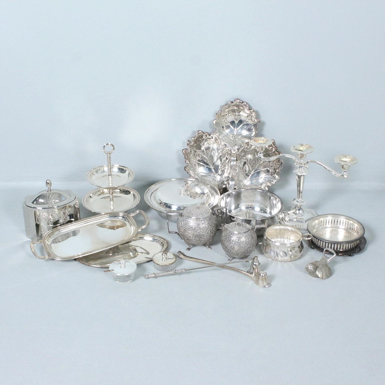 A large collection of silver-plated objects, some made of metal.