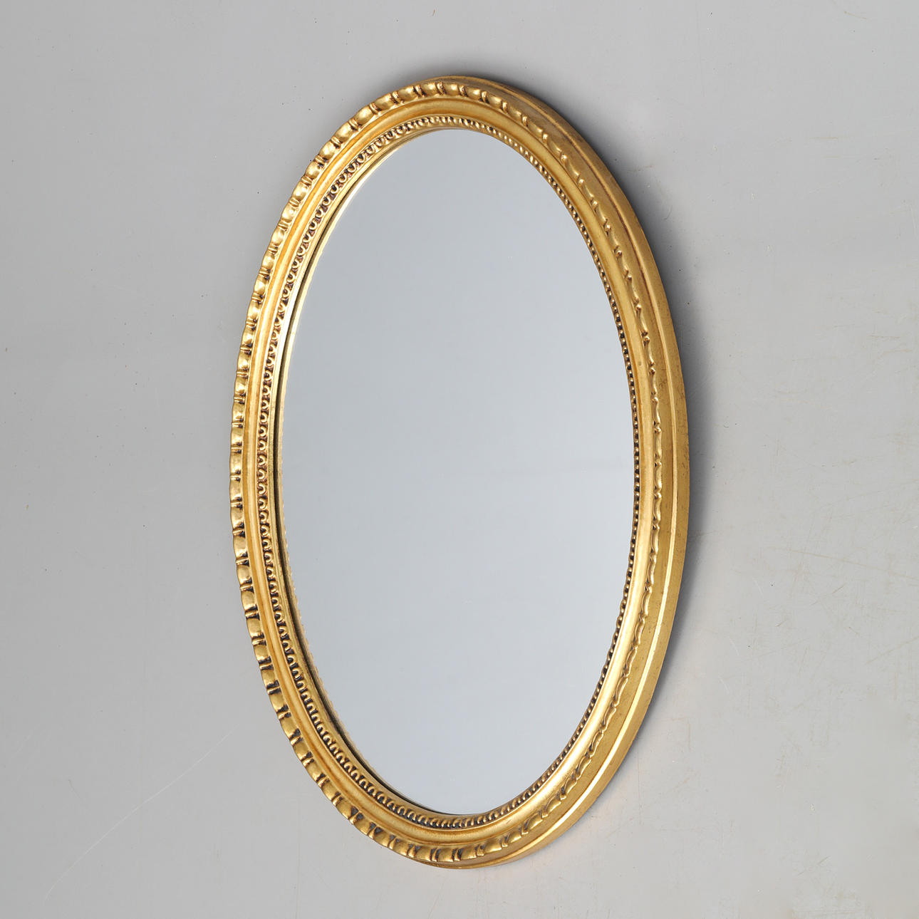 MIRROR, oval with gold colored frame.