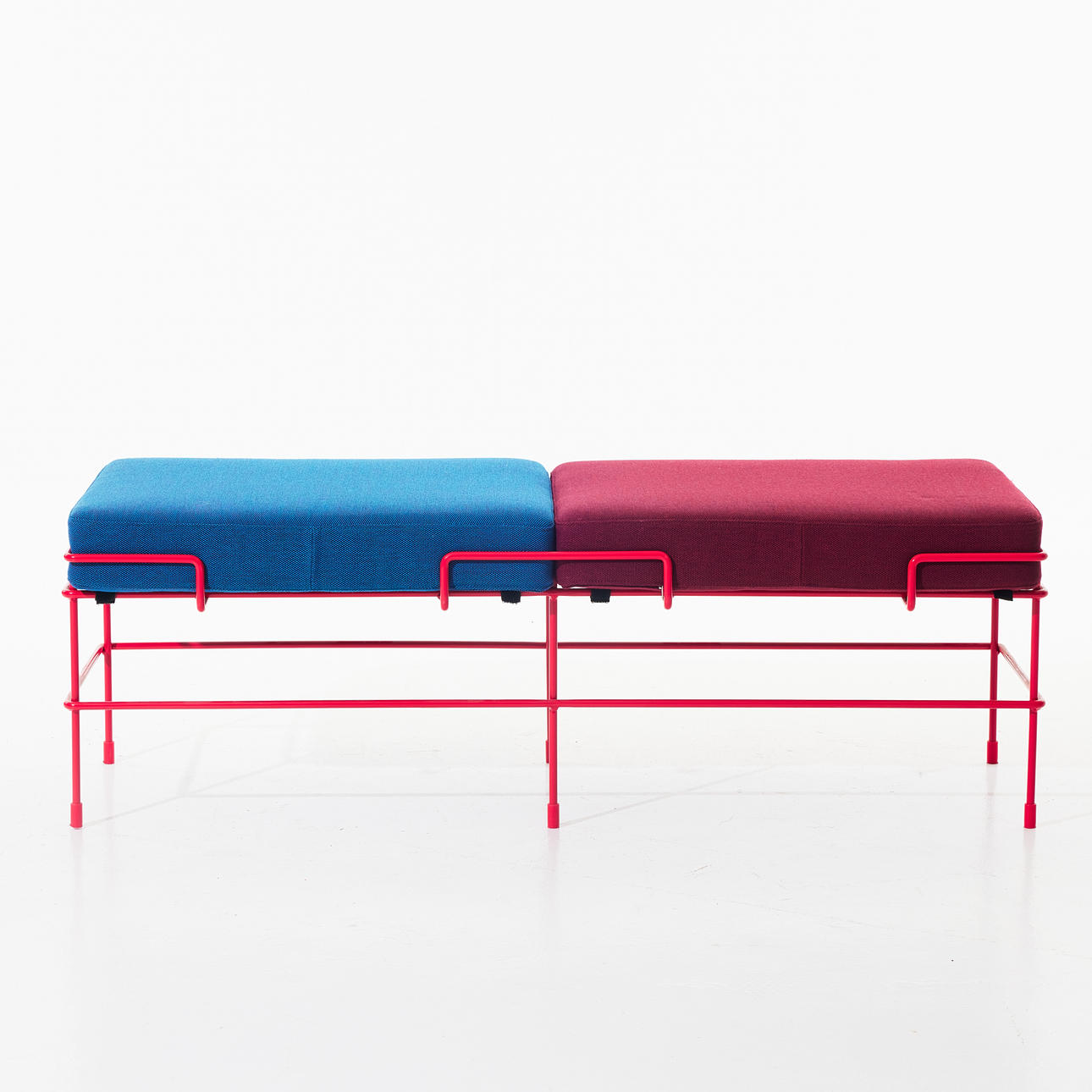 CONSTANTINE GRCIC. Bench "Traffic" for Magis, designed in 2013, base in red lacquered metal, textile covered cushions.