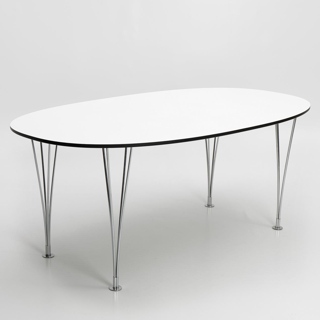 DINING TABLE, "Superellipse", specially ordered by Fritz Hansen, Denmark. Labeled Bruno Mathsson International, chromed tension legs, disc covered with white laminate, black edge.