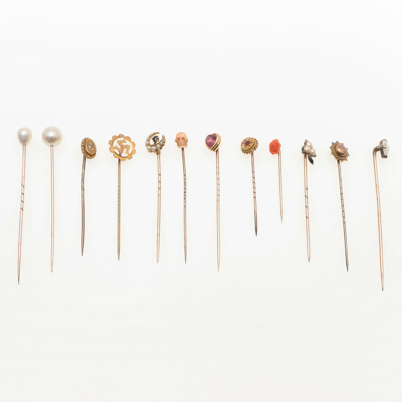 TWELVE ASSORTED GOLD STICKPINS.