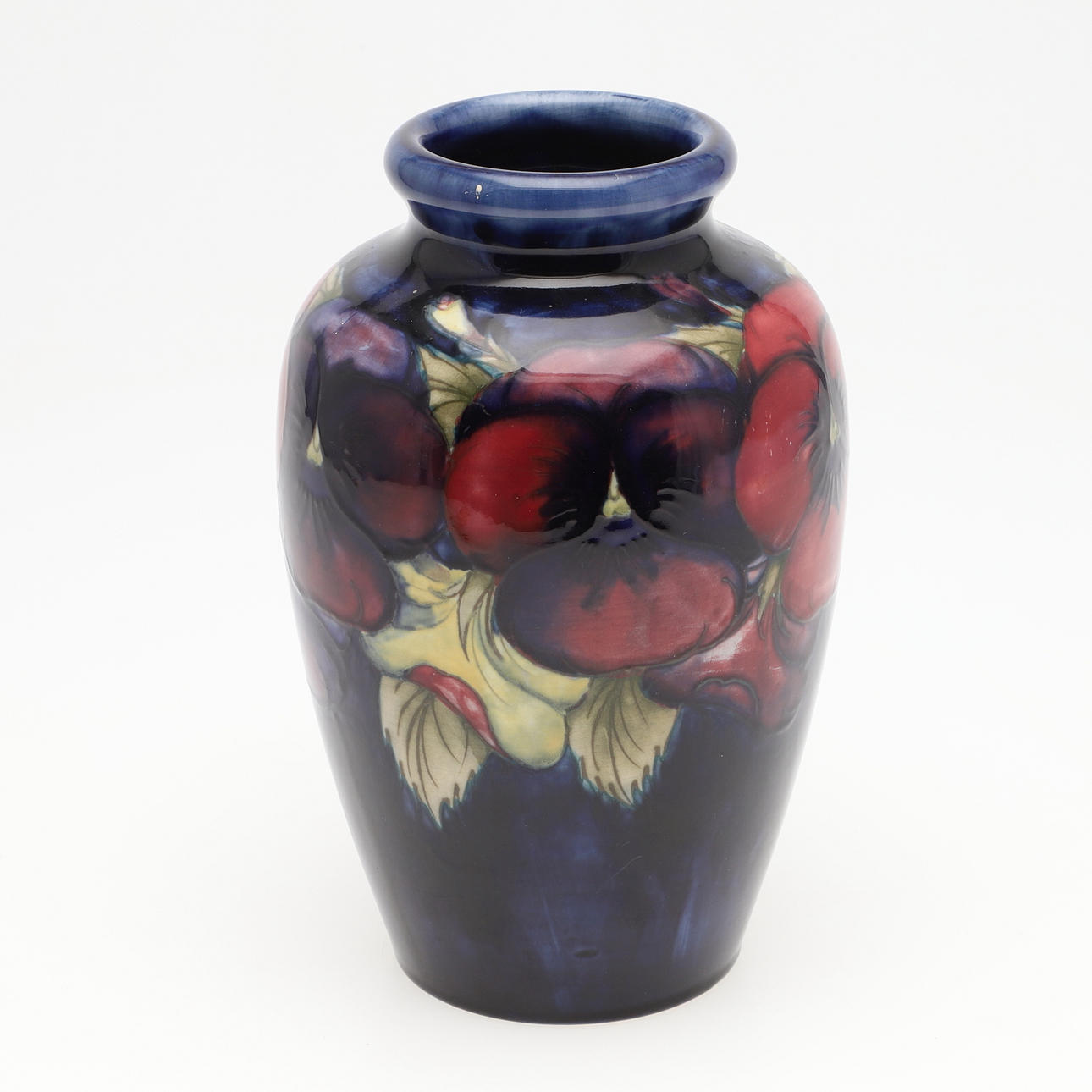 A MOORCROFT PANSY PATTERN VASE.