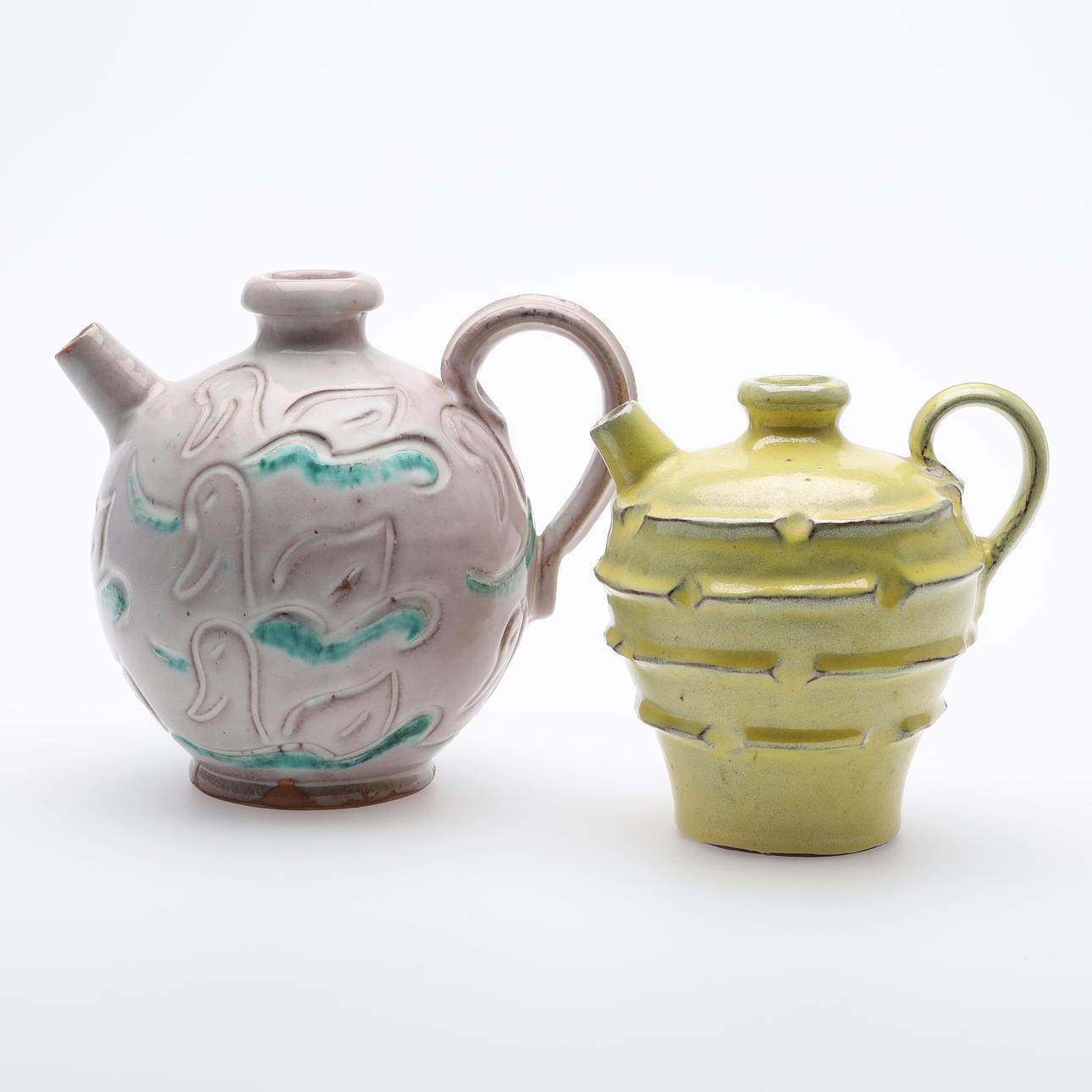 JUGS, glazed earthenware marked LA.