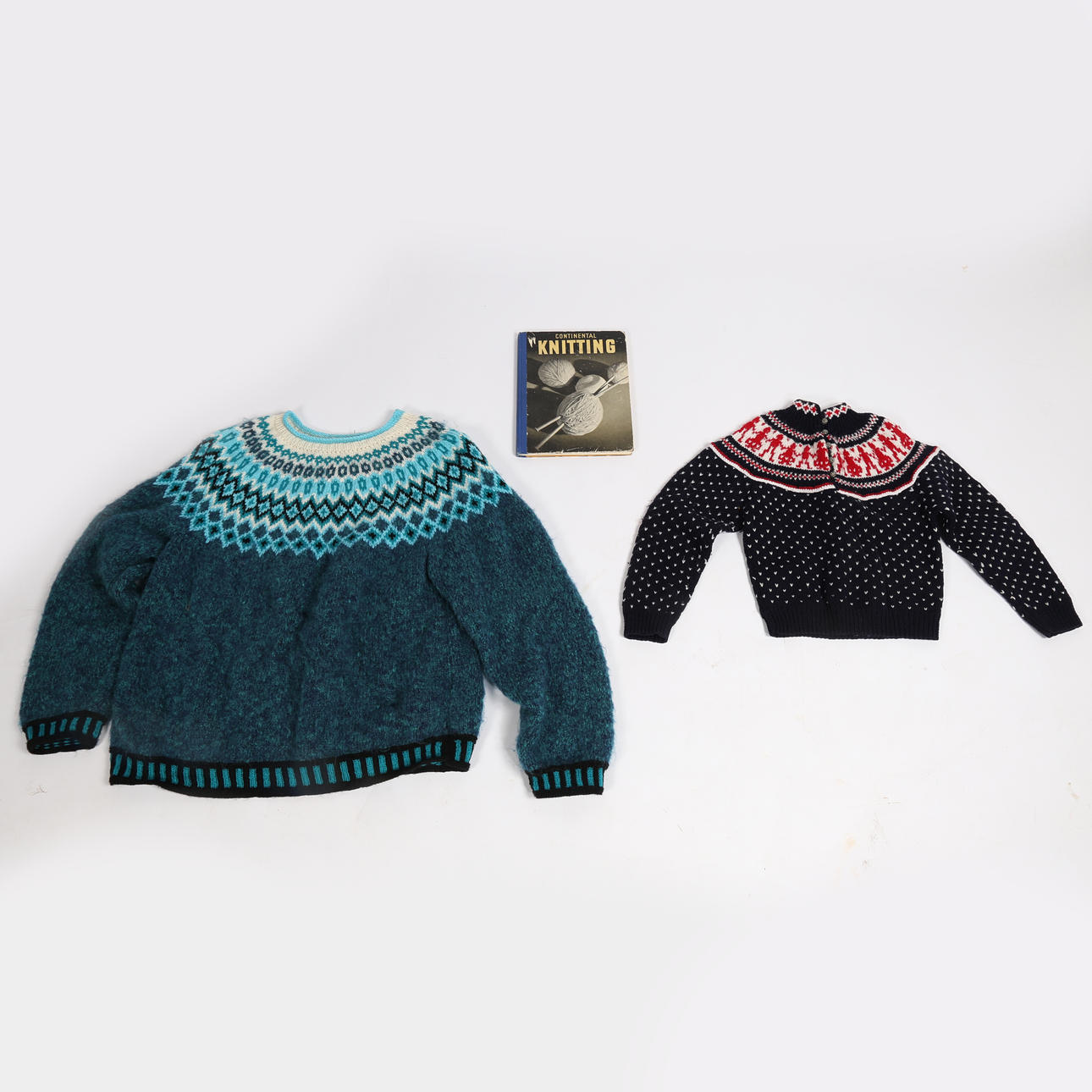 EIN NORDISCHER SKANDINAVISCHER HANDGESTRICKTER VINTAGE-PULLOVER, EIN HANDGESTRICKTER NORWEGISCHER PULLOVER FÜR KINDER UND EIN BUCH MIT STRICKMUSTERN.