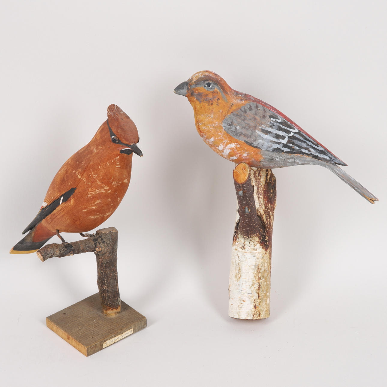 SCULPTURES, 2 birds, including silk tail, partly signed.