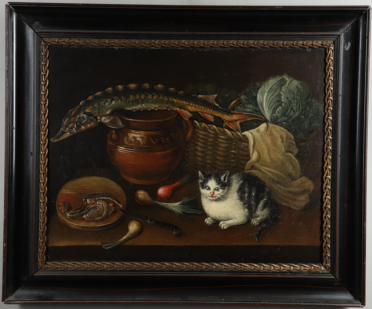 CIRCLE OF GEORGE SMITH OF CHICHESTER (1714-1776). KITCHEN STILL LIFE WITH A STURGEON, A CAT, VEGETABLES, AN EARTHENWARE BOWL AND A WICKER BASKET.