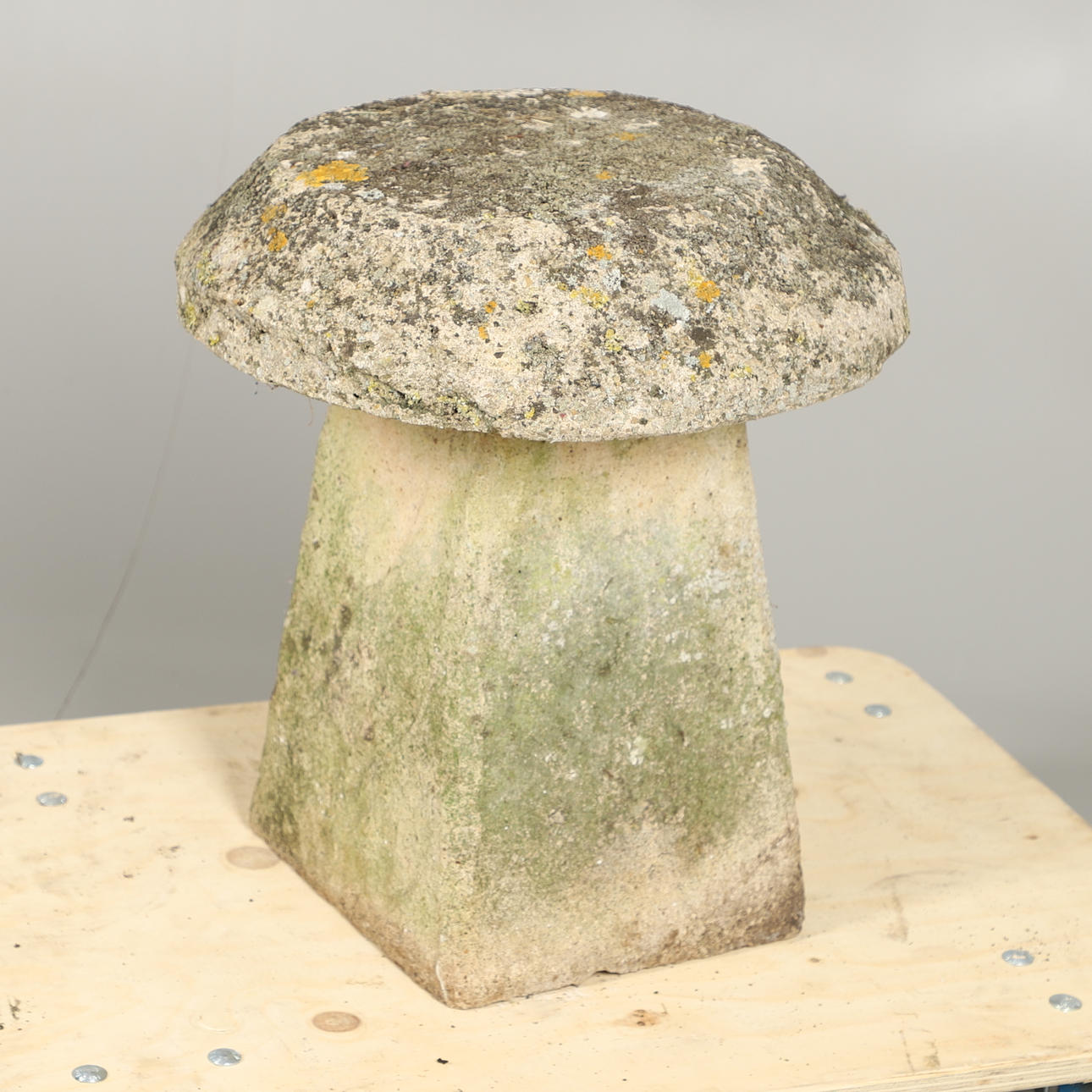 A RECONSTITUTED STONE STADDLE STONE.