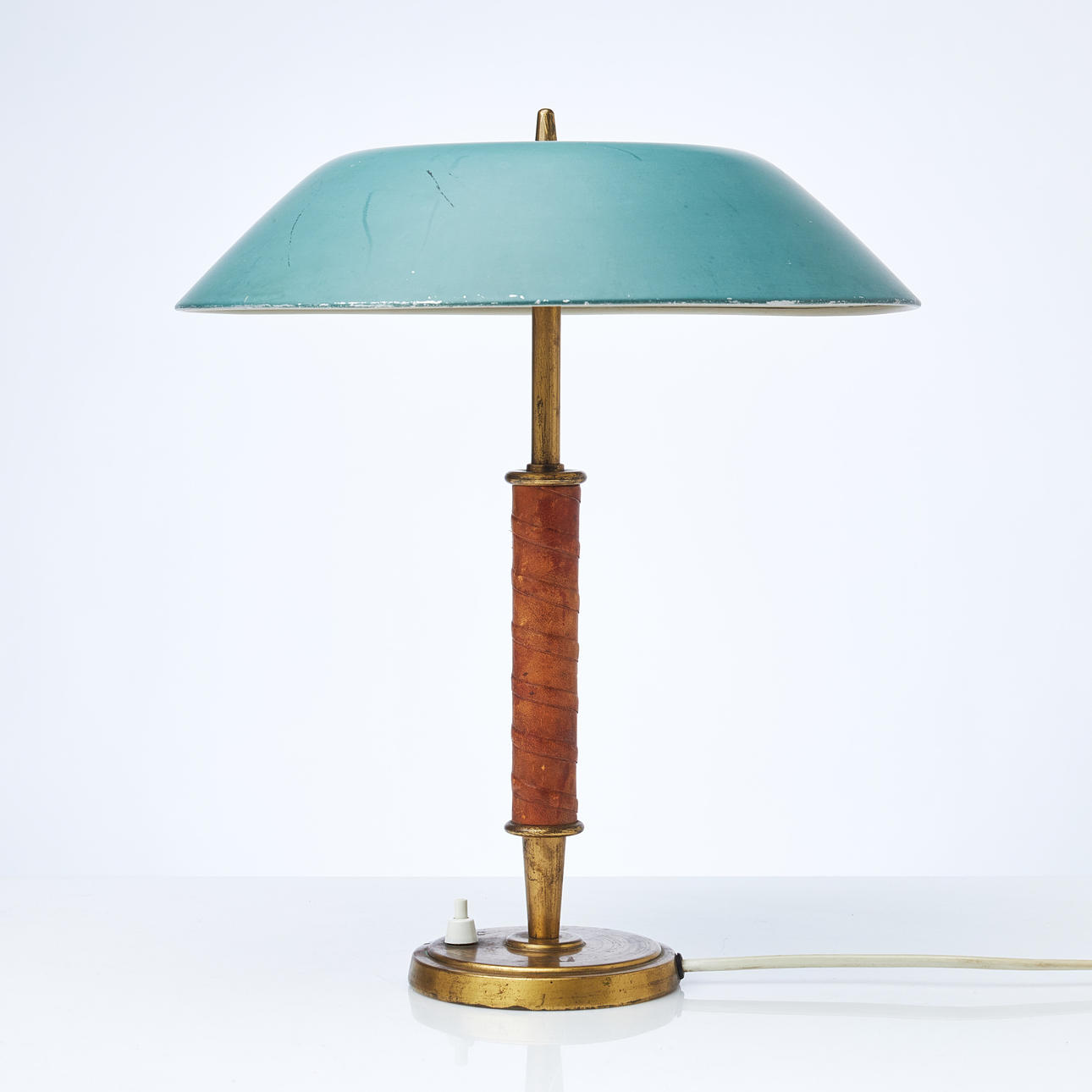 BERTIL BRISBORG. A table lamp, Nordiska Kompaniet, model 31044, first half of the 20th century, brass, leather-wrapped pillar, lacquered screen.