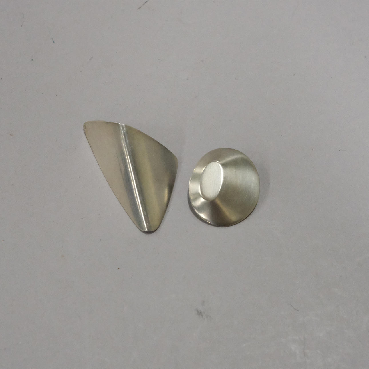 HANS HANSEN. TWO ODD EARRINGS, SILVER, FOR GEORG JENSEN.