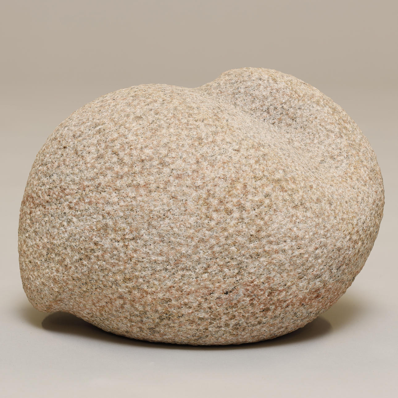 Stone sculpture. Sleeping bird. Red granite.