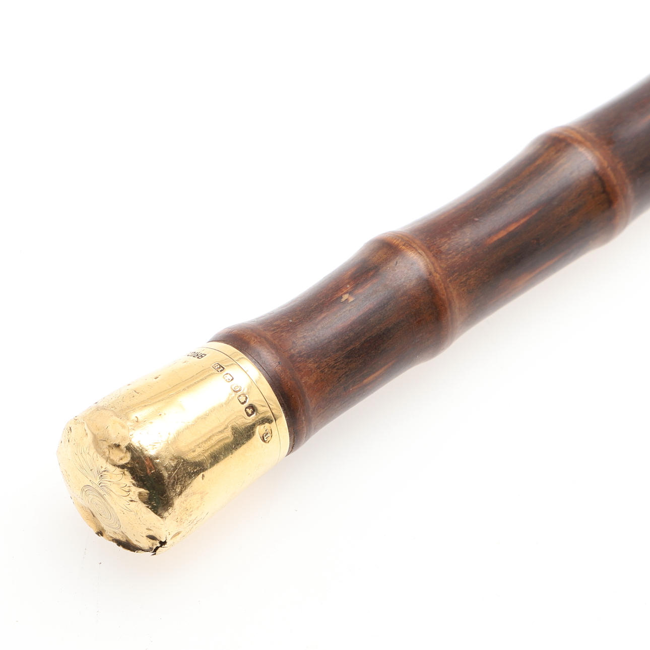 AN 18CT GOLD TOPPED BAMBOO CANE.