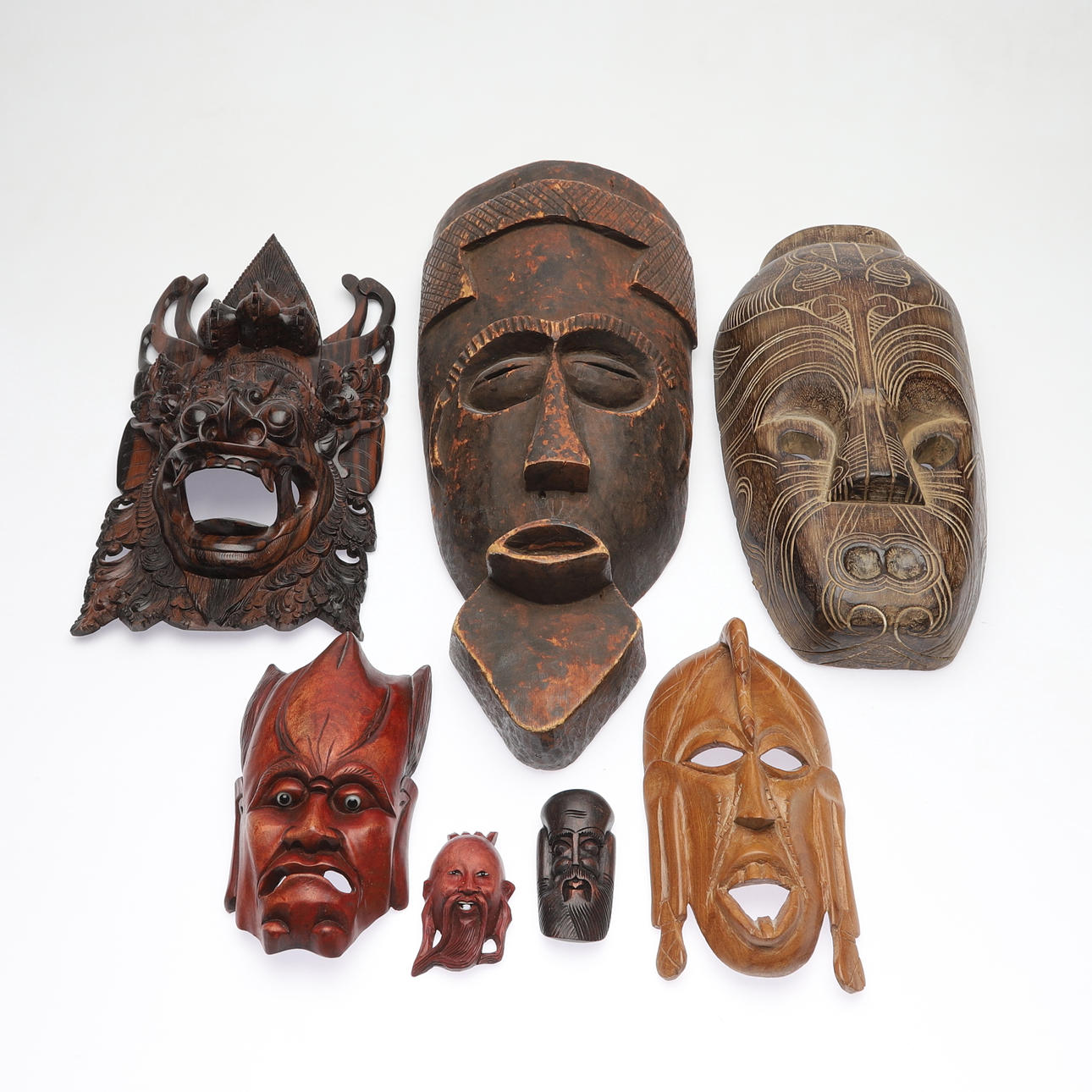 7 Holzmasken, Afrika, 20. Jahrhundert.