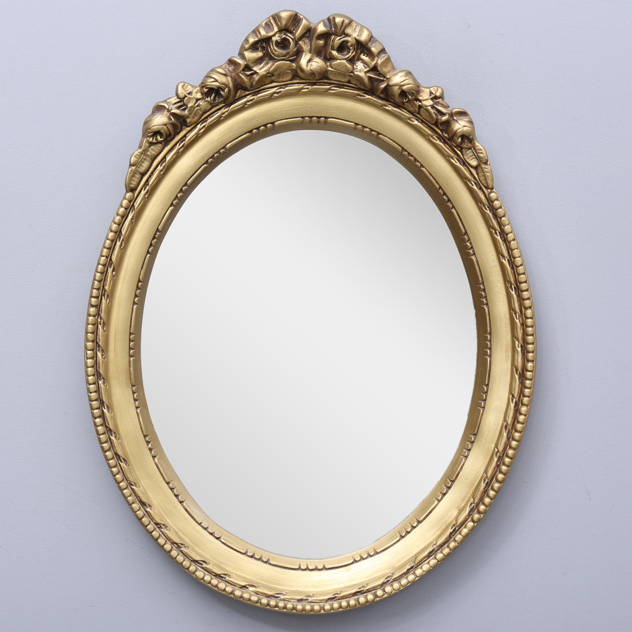 An oval mirror, mid 20th century.