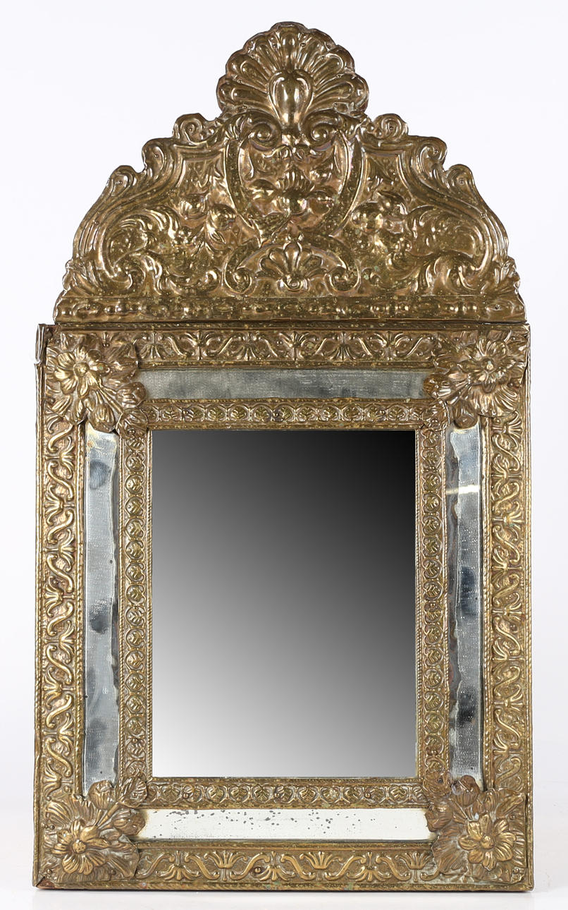 A 19TH CENTURY DUTCH PRESSED BRASS MIRROR.