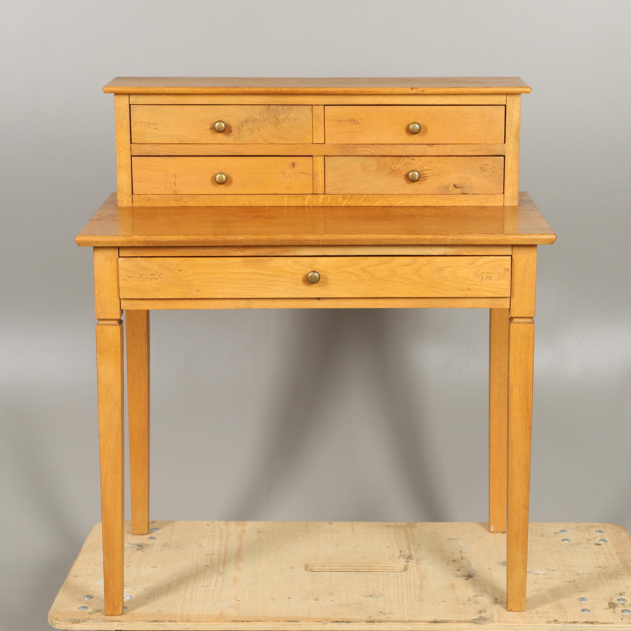 A MODERN LIGHT OAK WRITING DESK.