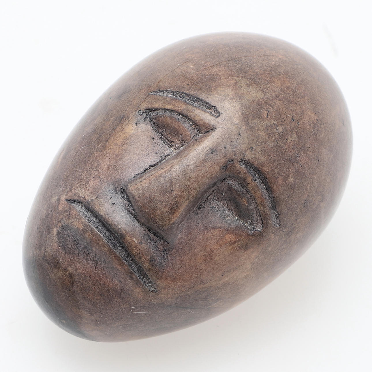 STONE HEAD, egg-shaped, face on two sides, unsigned.