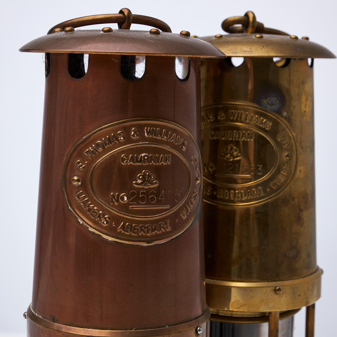 2 brass and glass mining lamps, 20th century, Marked: E