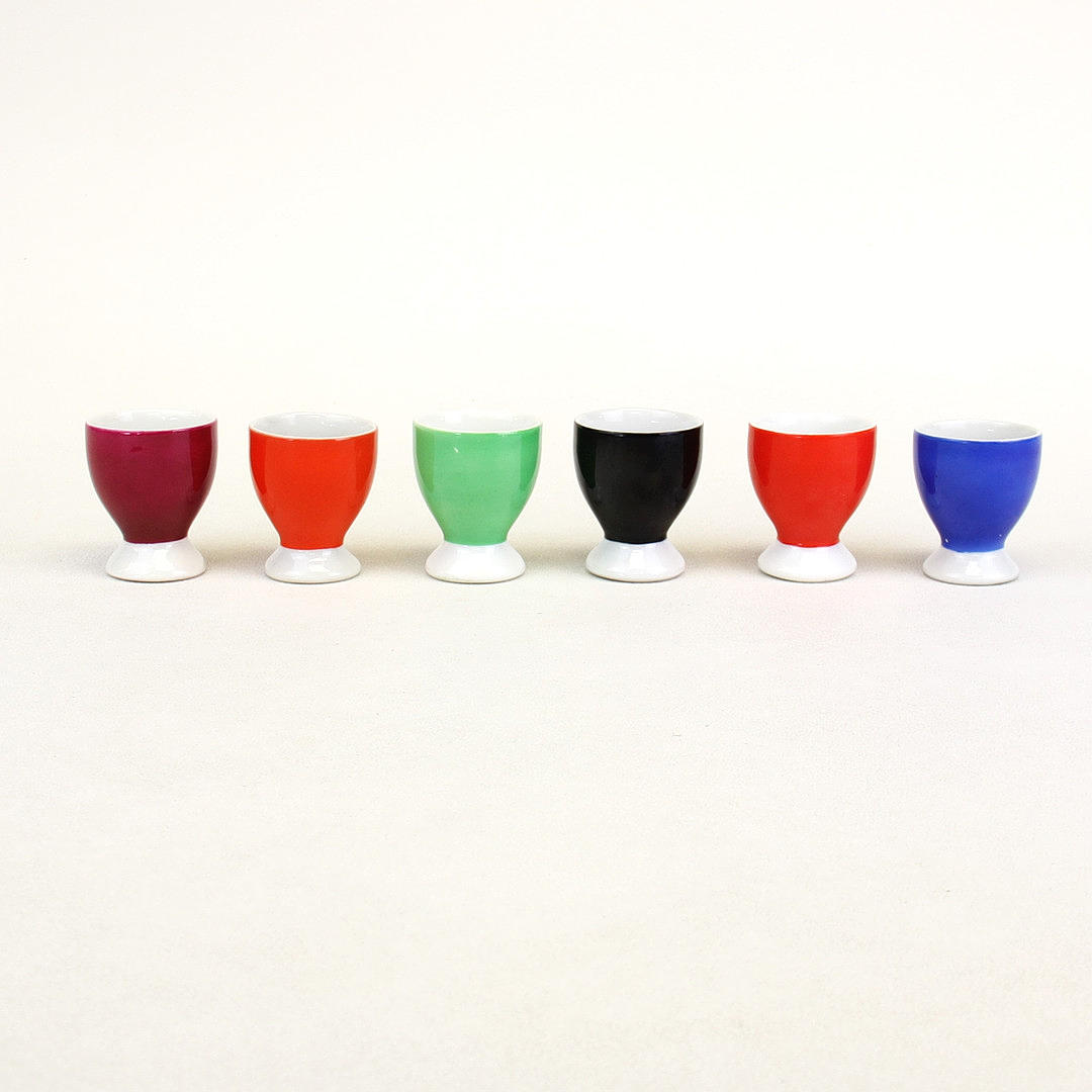 SIX COLOURFUL CHODZIE EGG CUPS.