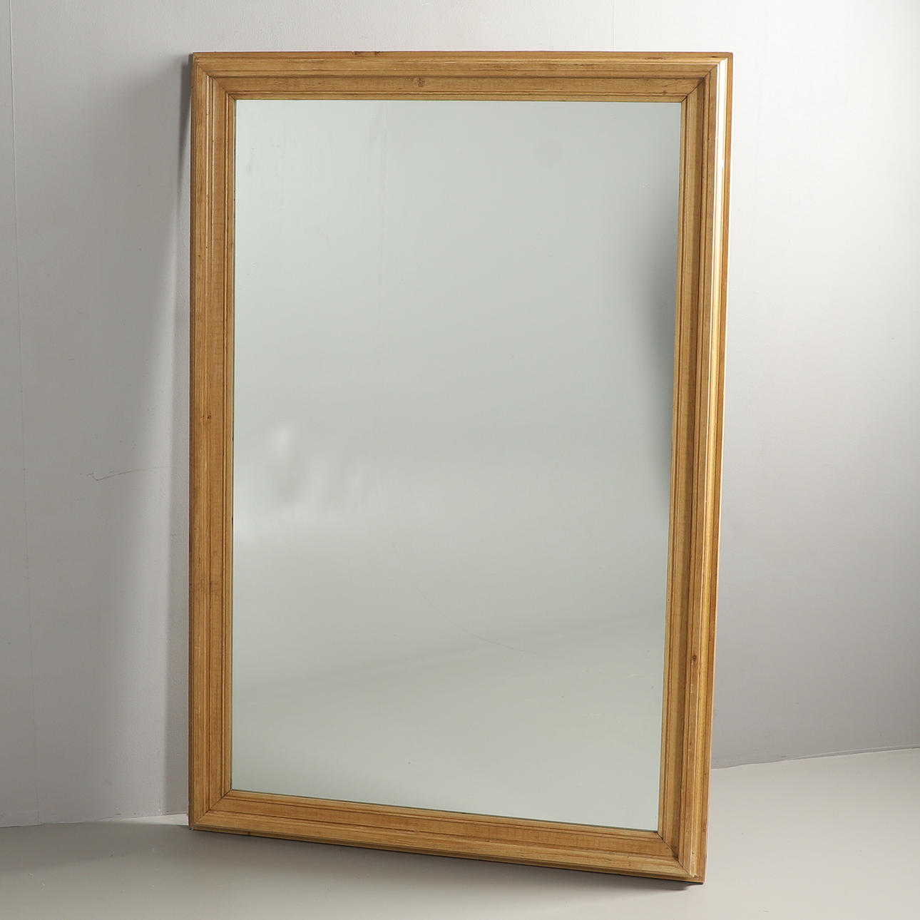A LARGE PINE FRAMED MIRROR.