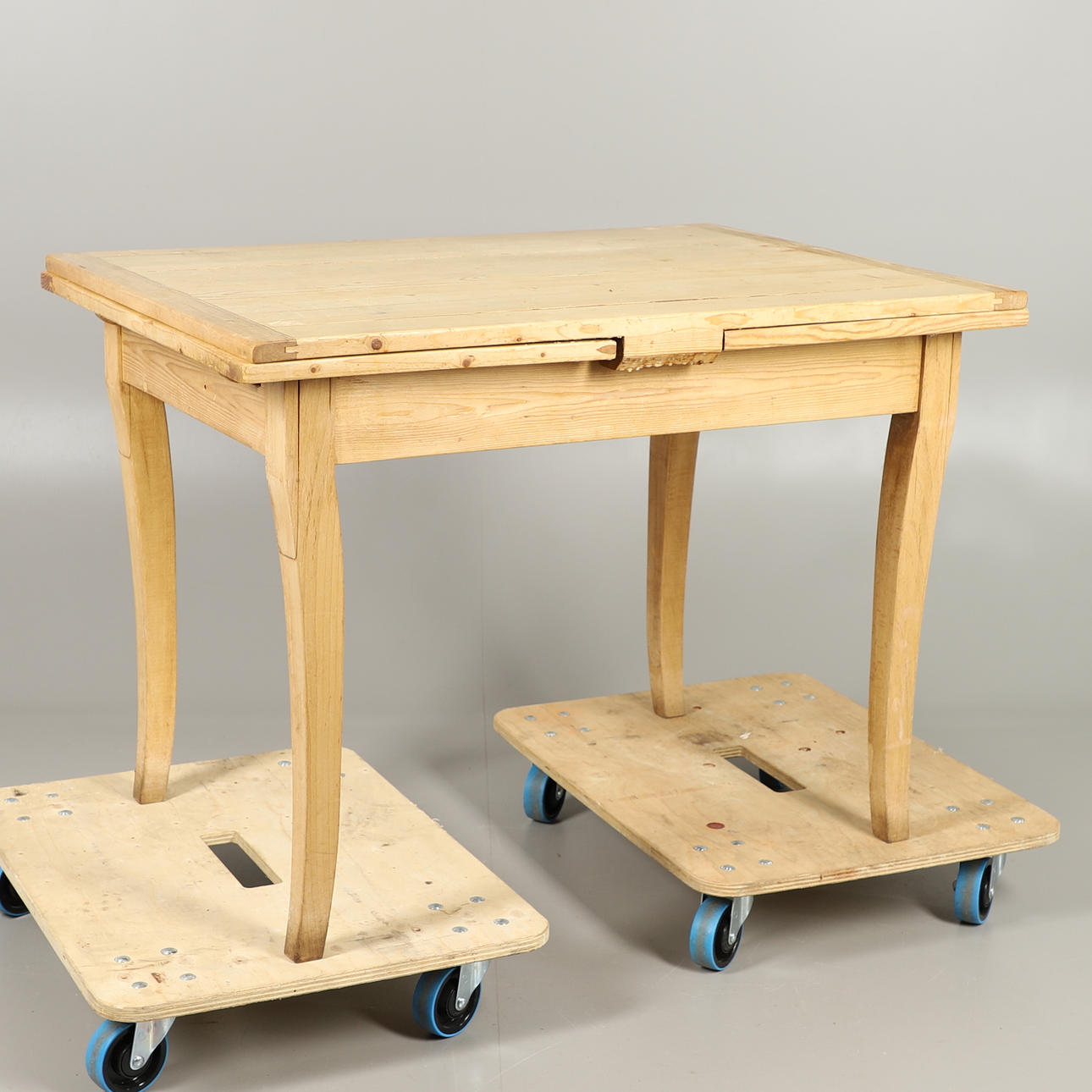 A CONTINENTAL STRIPPED PINE DRAW LEAF KITCHEN TABLE.