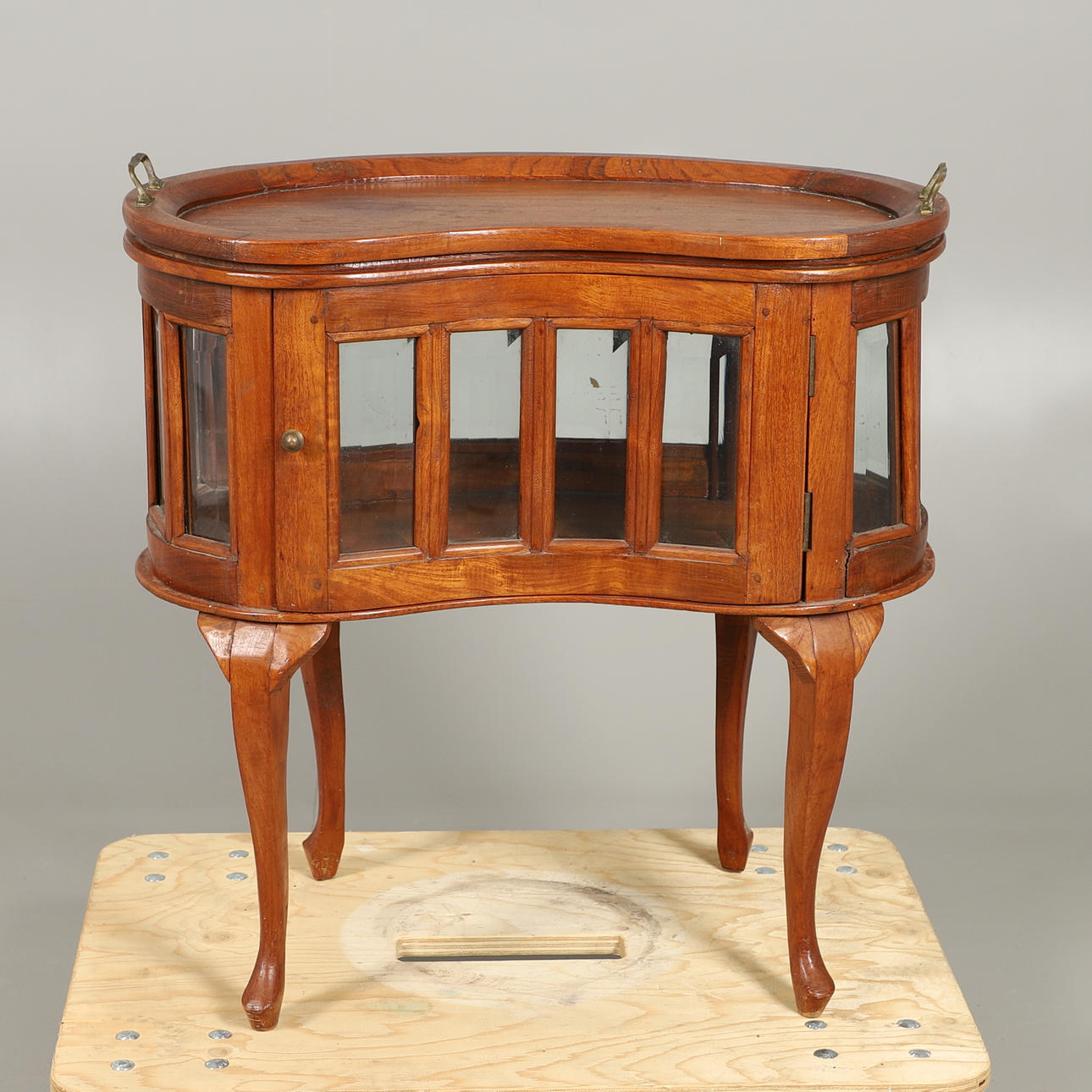 A GLAZED KIDNEY BEAN FORM CABINET.