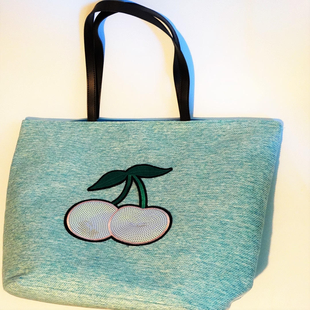 BAG, MADE OF FABRIC AND SEQUINS with cherry decoration.