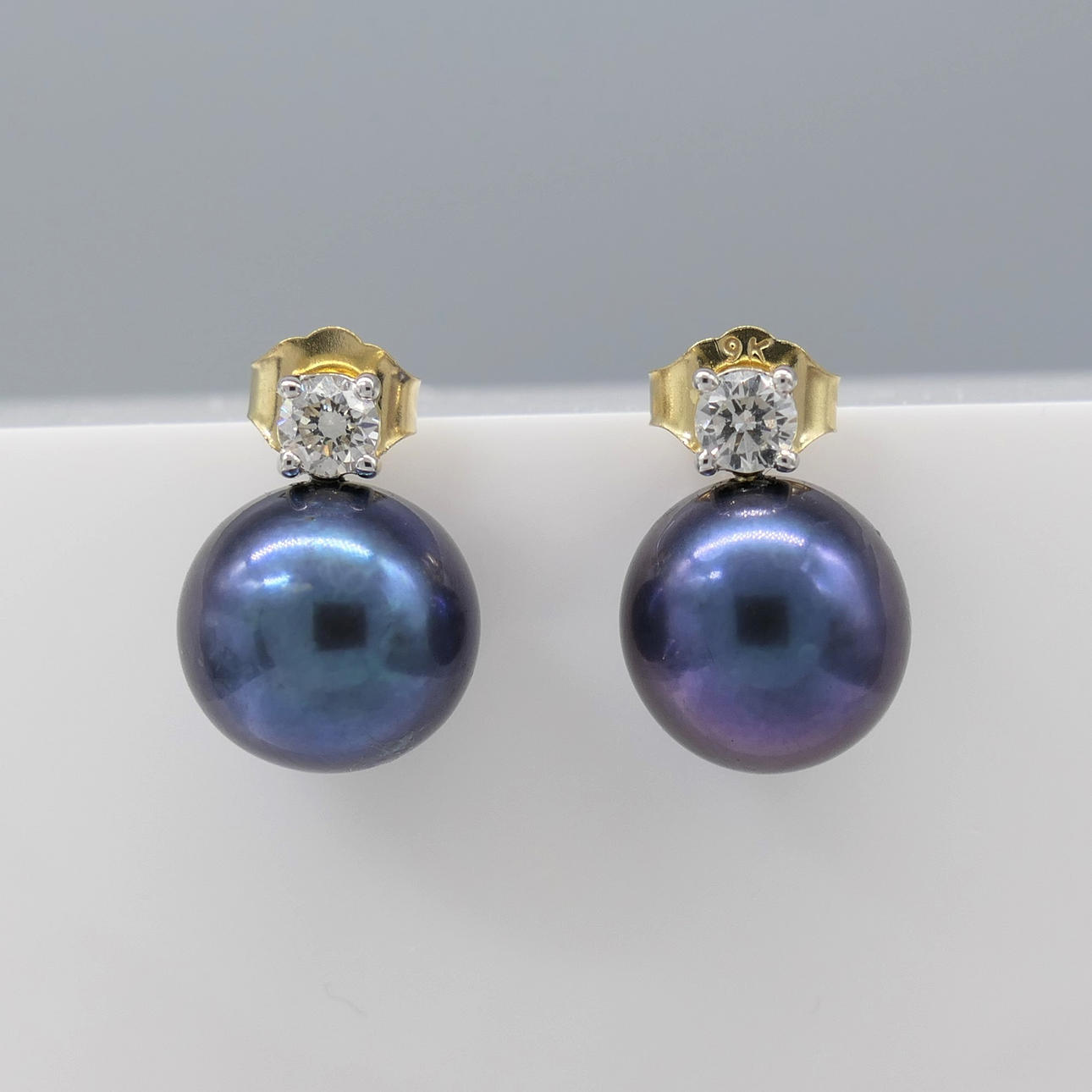 Ohrringe aus dunklen Perlen und DIAMANT.