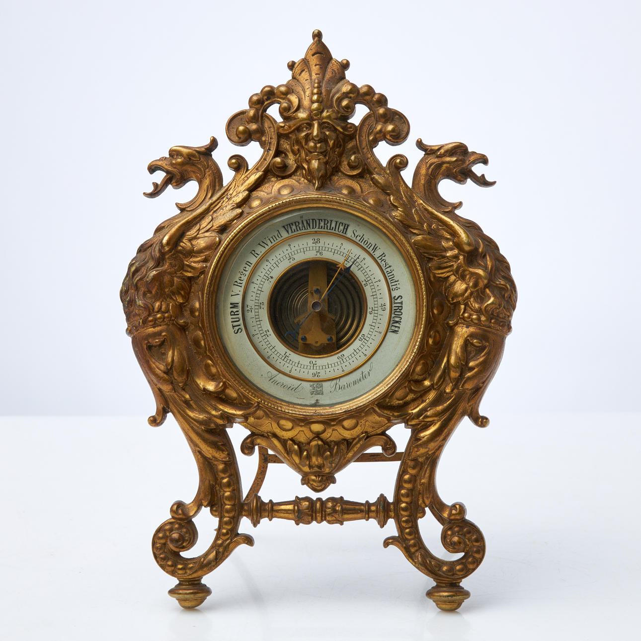 A 19th century barometer, marked Aneroïd Barometer, back cover dated 1833.