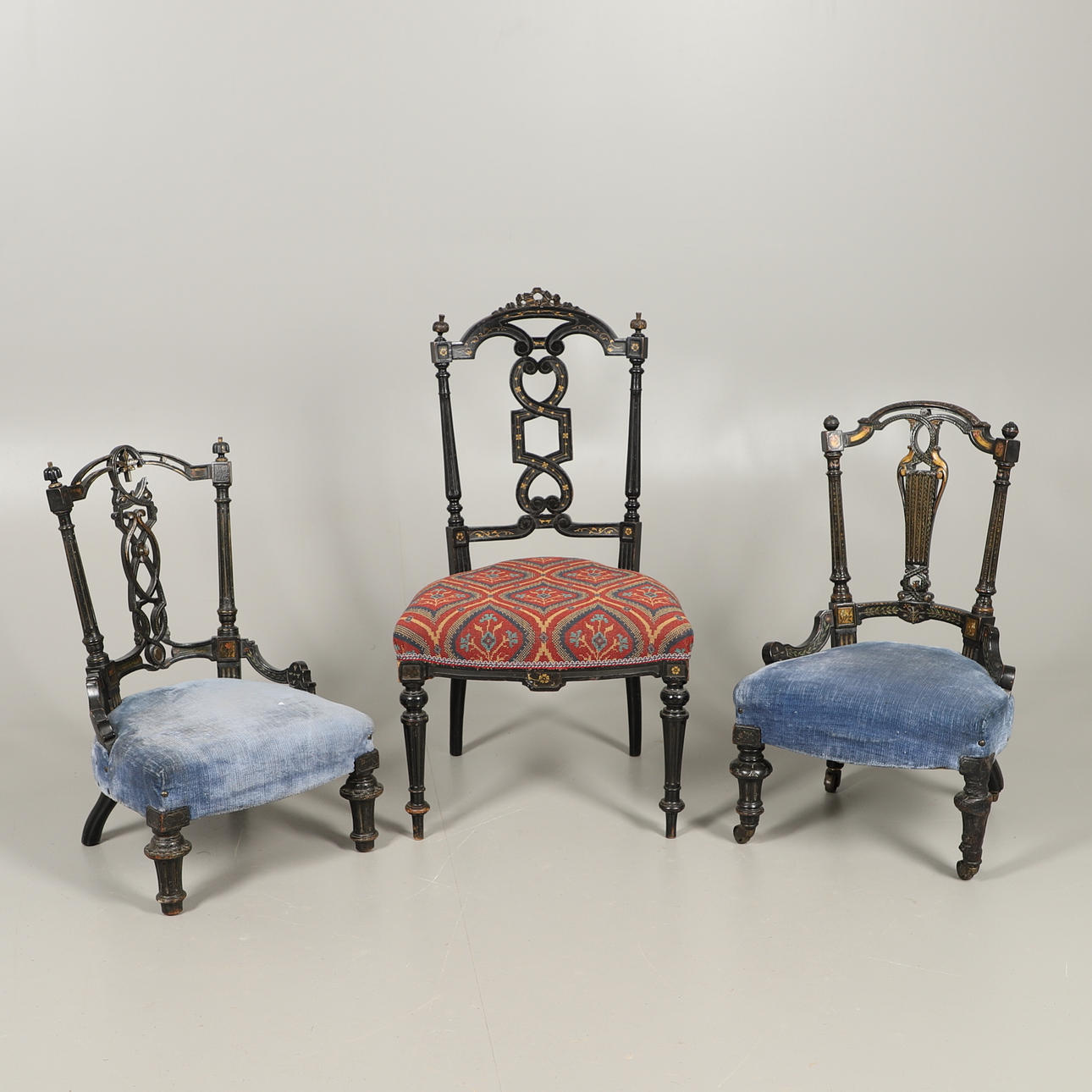 THREE VICTORIAN EBONISED SALON CHAIRS.