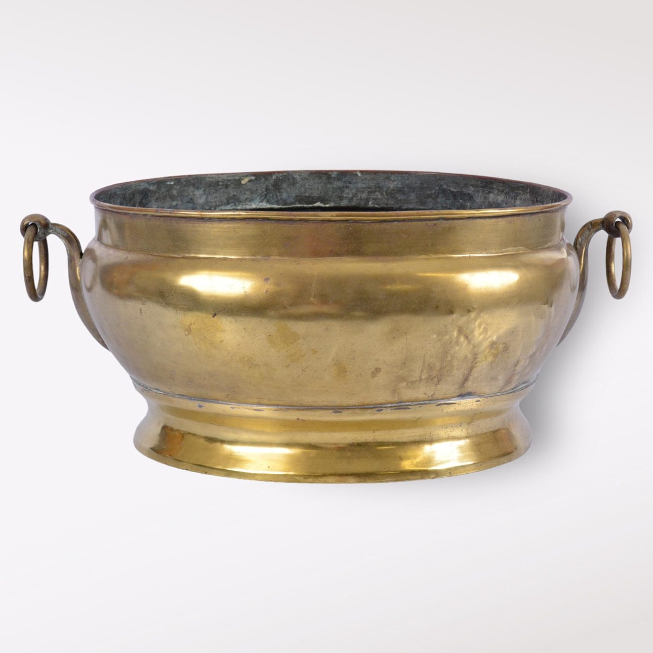 A 17th-century brass champagne cooler.