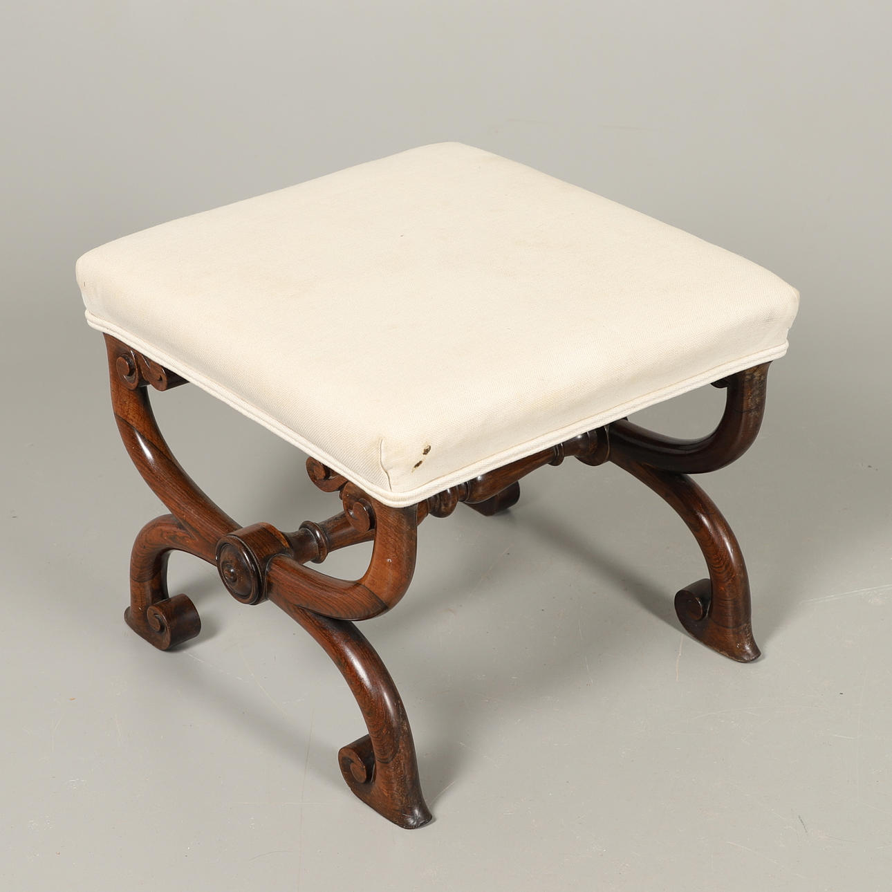 A VICTORIAN ROSEWOOD X FRAME STOOL.